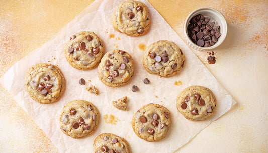Banana peanut butter protein cookies with chocolate chips on parchment
