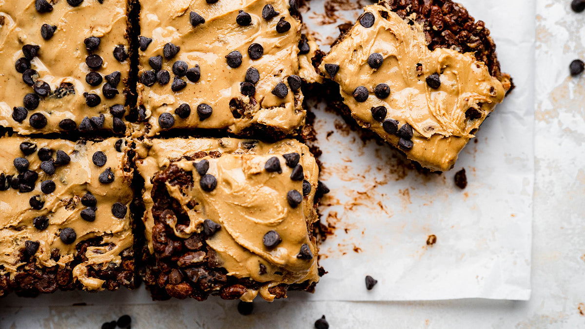 Chocolate protein crunch bars topped with peanut butter and chocolate chips