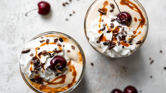 Vanilla banana protein nice-cream shakes with whipped cream and cherries