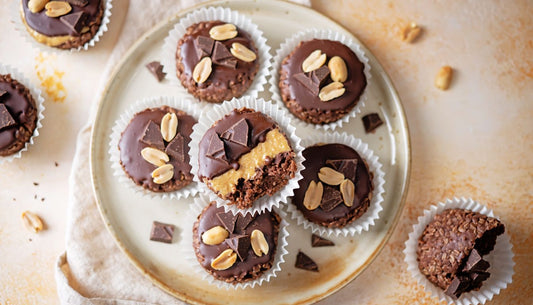 Chocolate peanut butter granola cups topped with peanuts