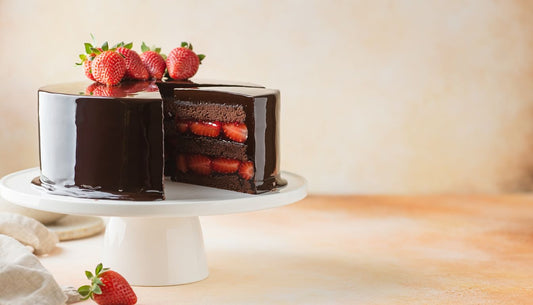 Dark chocolate strawberry layer cake with a cut slice