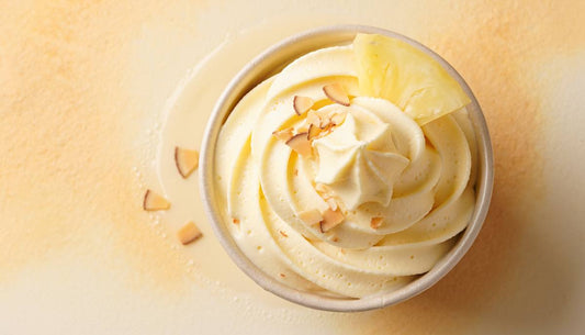 Pineapple protein soft-serve ice cream swirl topped with toasted coconut
