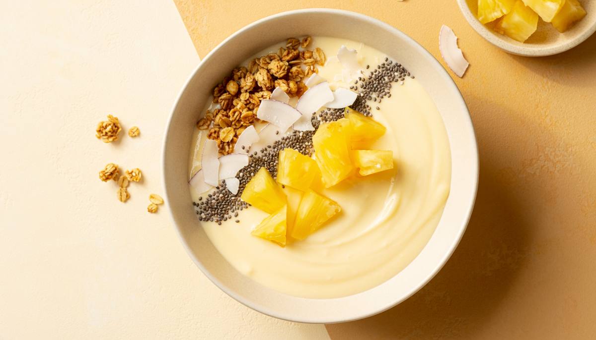 Pineapple protein yogurt bowl with granola, chia seeds, coconut, and pineapple