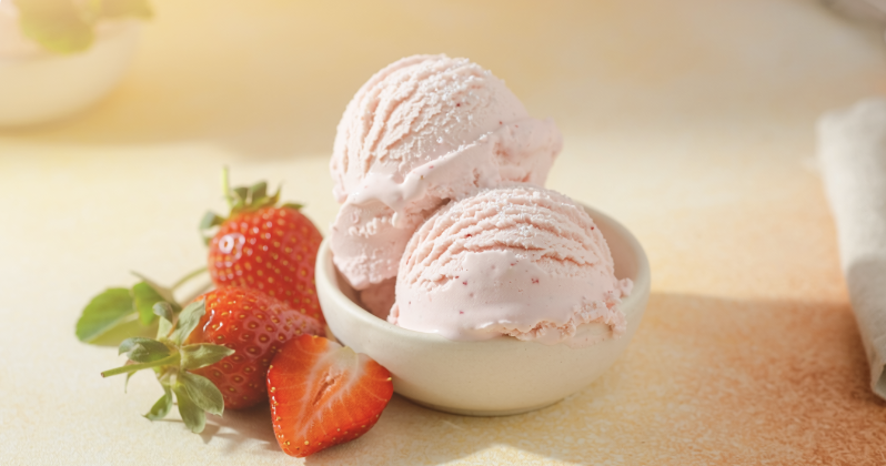 Strawberry protein ice cream scoops with fresh strawberries