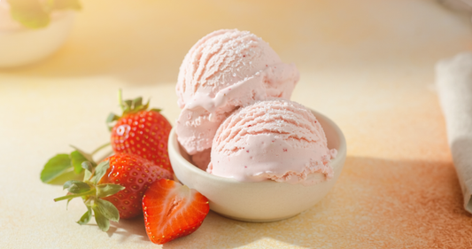 Strawberry protein ice cream scoops with fresh strawberries