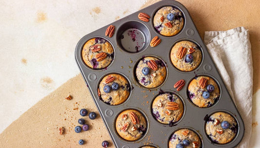 Vegan blueberry protein muffins in a muffin tin