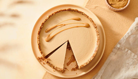 Vegan peanut butter protein cheesecake with an oat crust and a slice removed